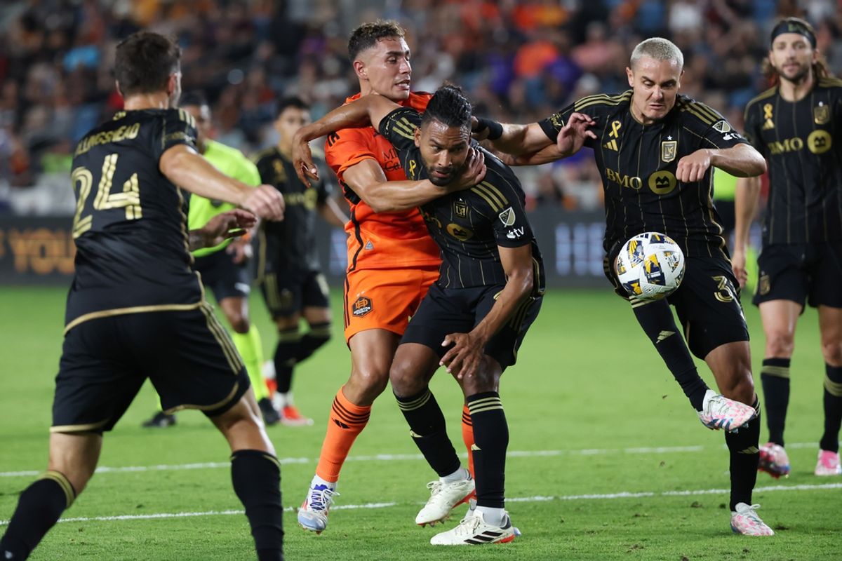 Sep 7, 2024; Houston, Texas, USA; LAFC defender Aaron Long (33) and defender Eddie Segura (4) battle for the ball against Houston Dynamo FC forward Ezequiel Ponce (10) in the second half at Shell Energy Stadium. Mandatory Credit: Thomas Shea-Imagn Images