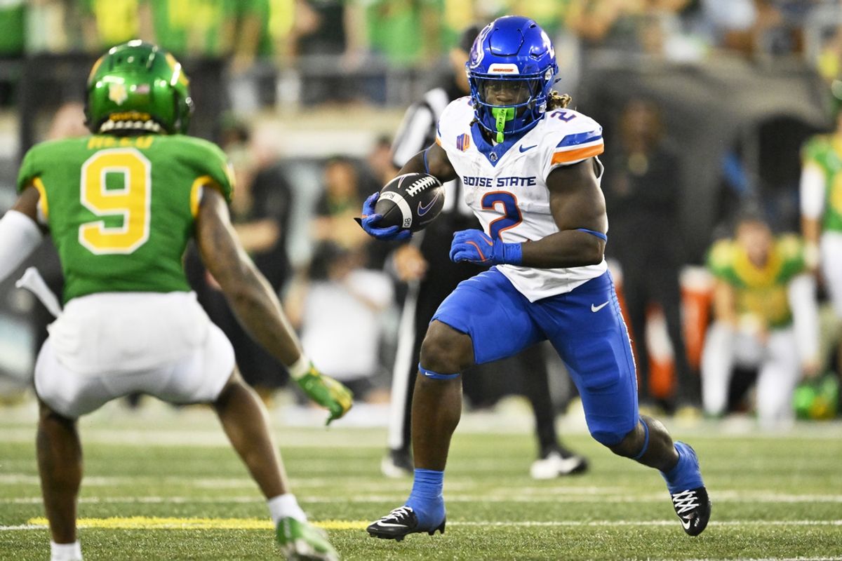 Sep 7, 2024; Eugene, Oregon, USA; Boise State Broncos running back Ashton Jeanty (2) rushes for a first down during the first half against Oregon Ducks defensive back Nikko Reed (9) at Autzen Stadium. Mandatory Credit: Troy Wayrynen-Imagn Images