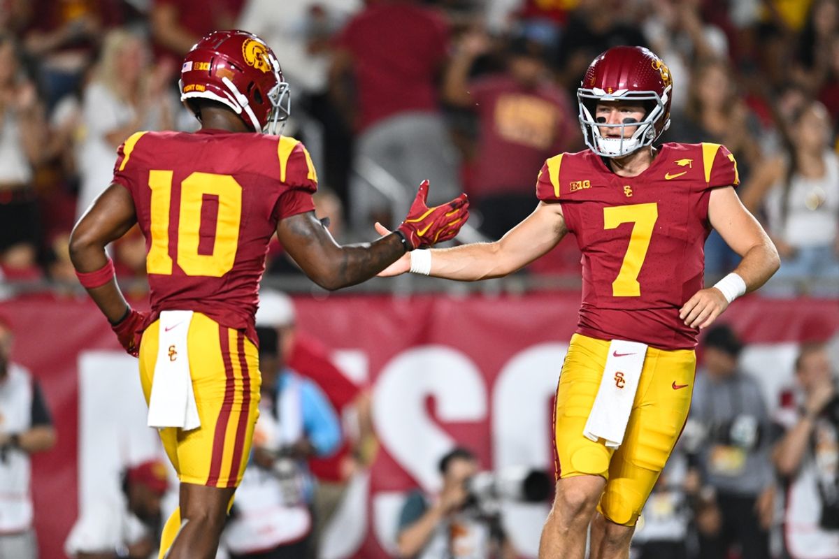 Sep 7, 2024; Los Angeles, California, USA; USC Trojans quarterback Miller Moss (7) celebrates with USC Trojans wide receiver Kyron Hudson (10) after scoring a touchdown against Utah State Aggies during the first quarter at United Airlines Field at Los Angeles Memorial Coliseum. Mandatory Credit: Jonathan Hui-Imagn Images