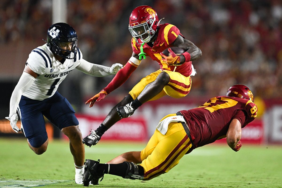 Sep 7, 2024; Los Angeles, California, USA; USC Trojans wide receiver Zachariah Branch (1) runs the ball against Utah State Aggies linebacker Jon Ross Maye (1) during the second quarter at United Airlines Field at Los Angeles Memorial Coliseum. Mandatory Credit: Jonathan Hui-Imagn Images