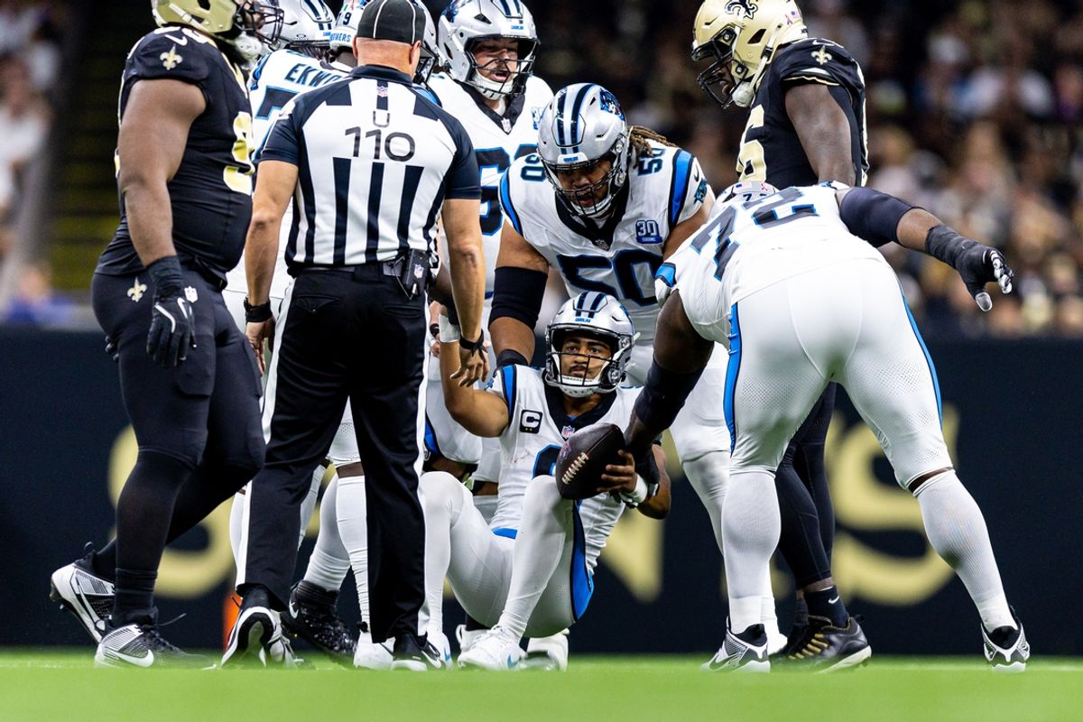 Sep 8, 2024; New Orleans, Louisiana, USA;  Carolina Panthers quarterback Bryce Young (9) helped off the turf after a sack against the New Orleans Saints during the first half at Caesars Superdome. Mandatory Credit: Stephen Lew-Imagn Images
