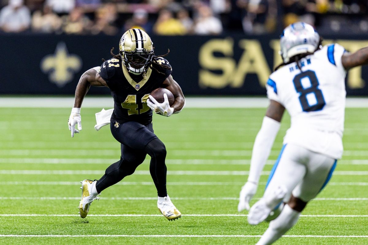 Sep 8, 2024; New Orleans, Louisiana, USA;  New Orleans Saints running back Alvin Kamara (41) runs against Carolina Panthers cornerback Jaycee Horn (8) during the first half at Caesars Superdome. Mandatory Credit: Stephen Lew-Imagn Images
