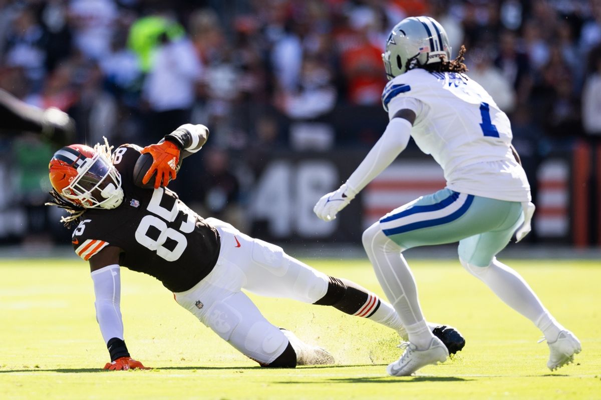 Sep 8, 2024; Cleveland, Ohio, USA; Cleveland Browns tight end David Njoku (85) falls while running the ball under coverage by Dallas Cowboys cornerback Trevon Diggs (7) during the first quarter at Huntington Bank Field. Mandatory Credit: Scott Galvin-Imagn Images