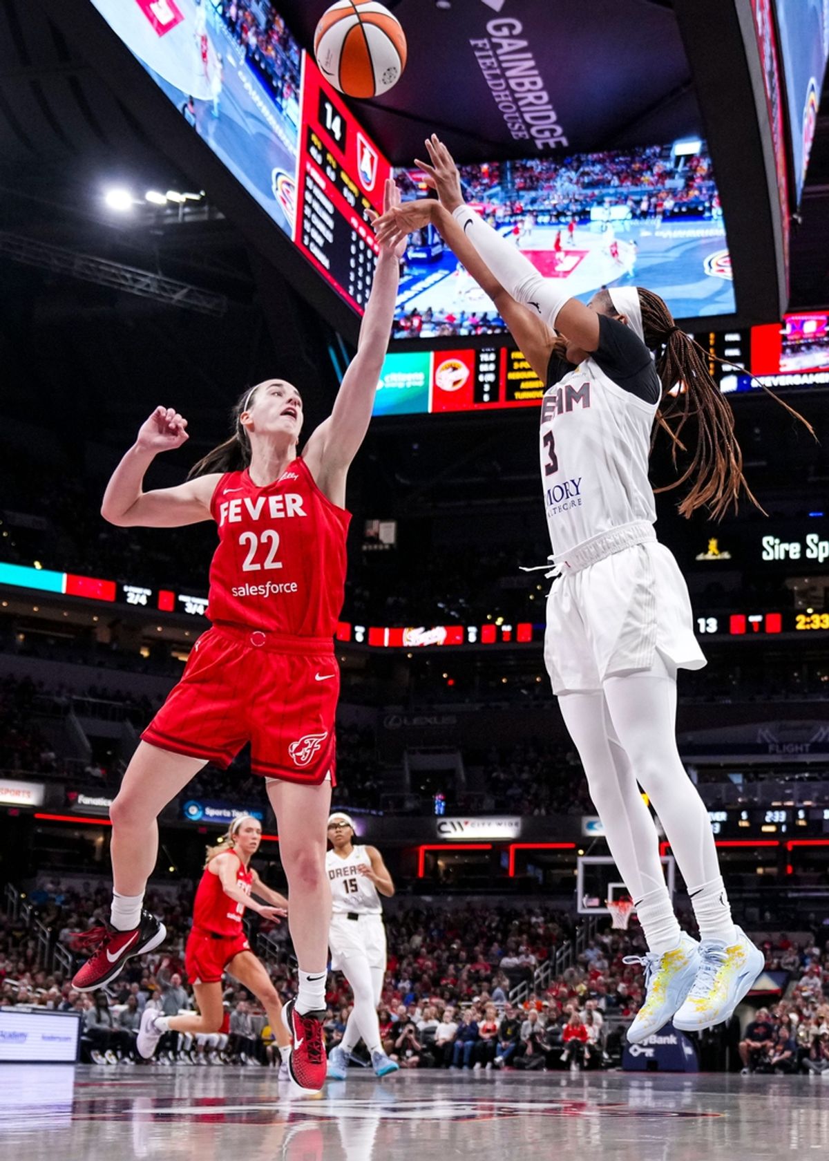 Atlanta Dream guard Jordin Canada (3) goes up for a shot against Indiana Fever guard Caitlin Clark (22) on Sunday, Sept. 8, 2024, during a game between the Indiana Fever and the Atlanta Dream at Gainbridge Fieldhouse in Indianapolis.