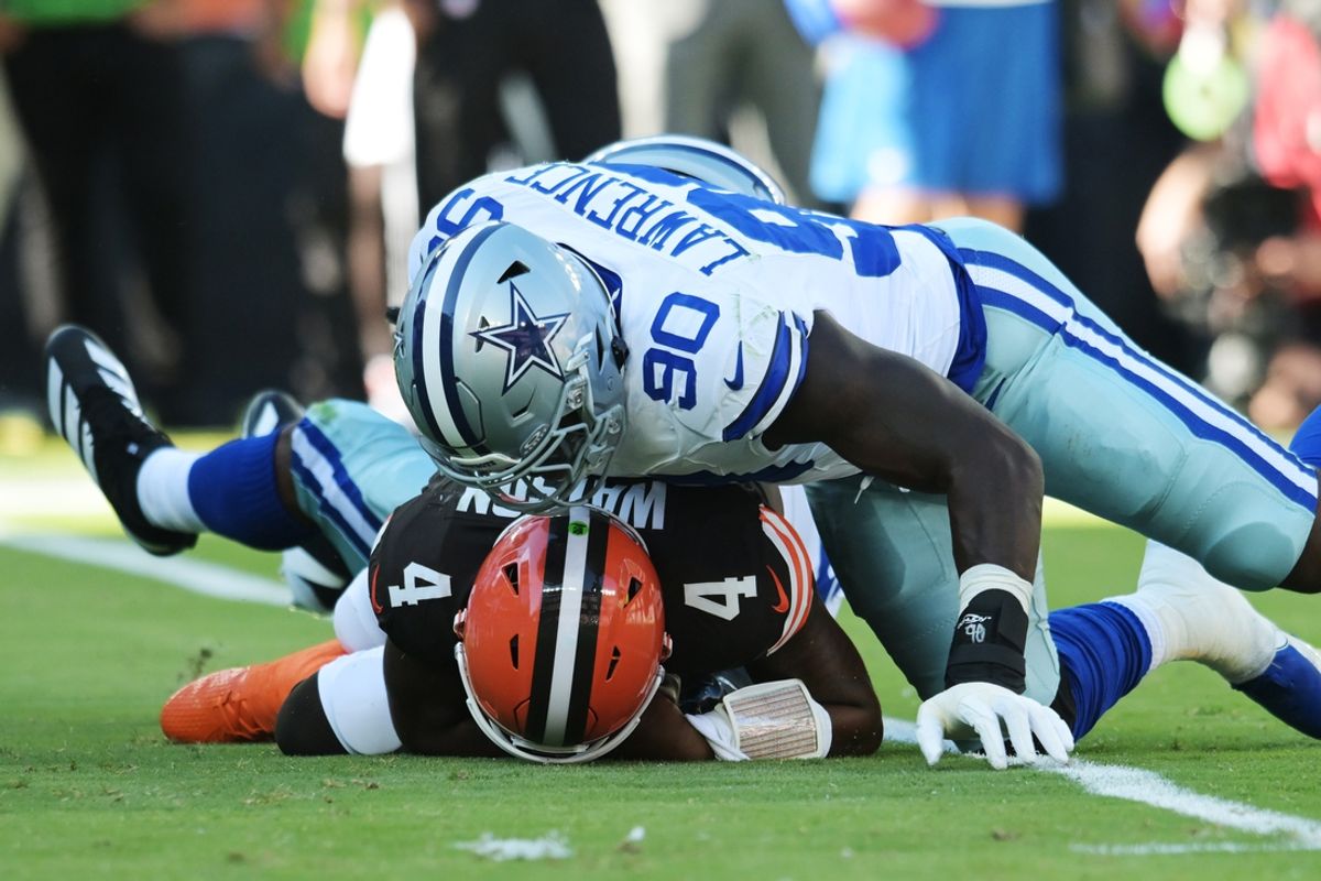 Sep 8, 2024; Cleveland, Ohio, USA; Dallas Cowboys defensive end DeMarcus Lawrence (90) lies on top of Cleveland Browns quarterback Deshaun Watson (4) after a sack during the first quarter at Huntington Bank Field. Mandatory Credit: Ken Blaze-Imagn Images