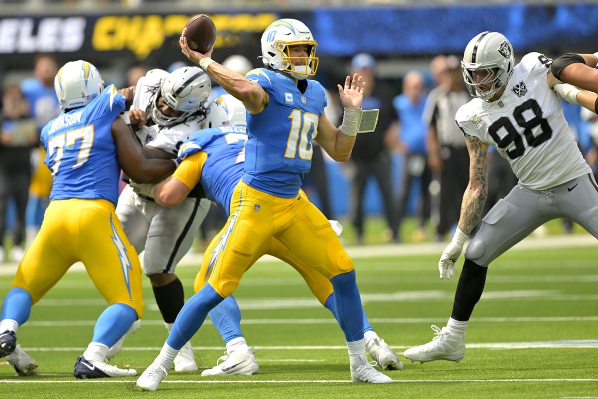 Sep 8, 2024; Inglewood, California, USA; Los Angeles Chargers quarterback Justin Herbert (10) looks to pass in the first half against the Las Vegas Raiders at SoFi Stadium. Mandatory Credit: Jayne Kamin-Oncea-Imagn Images