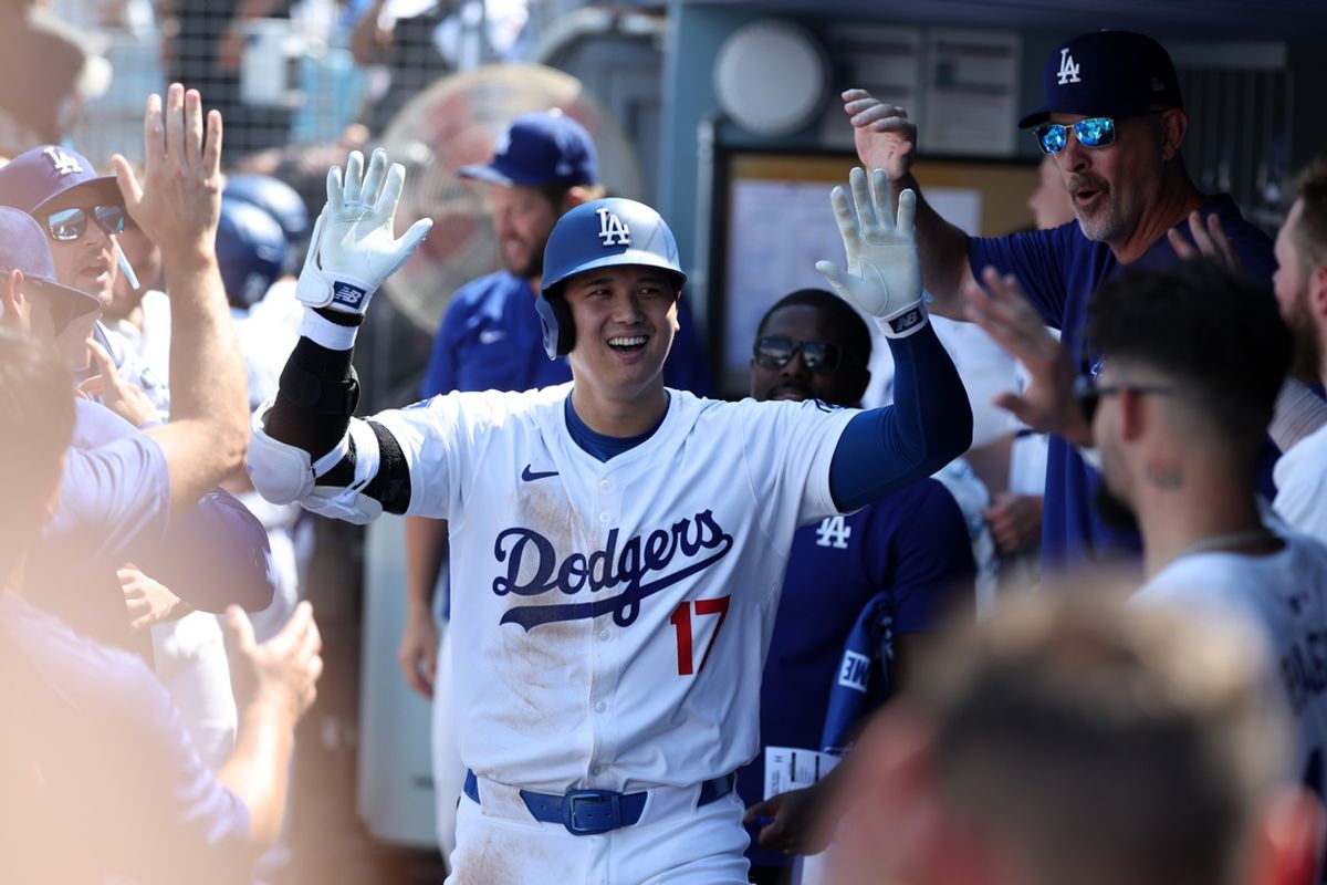 Sep 8, 2024; Los Angeles, California, USA;  Los Angeles Dodgers designated hitter Shohei Ohtani (17) is greeted in the dugout after hitting a home run during the fifth inning against the Cleveland Guardians at Dodger Stadium. Mandatory Credit: Kiyoshi Mio-Imagn Images