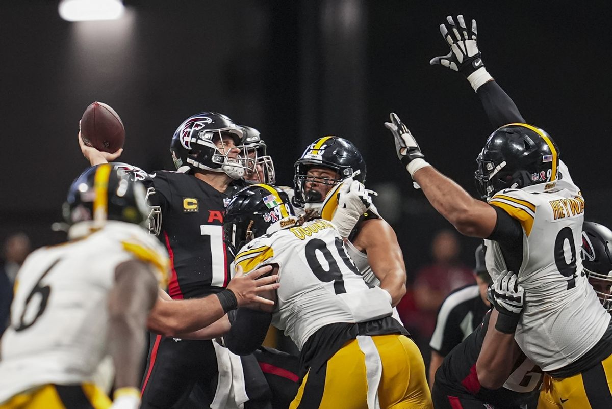 Sep 8, 2024; Atlanta, Georgia, USA; Atlanta Falcons quarterback Kirk Cousins (18) is hit by Pittsburgh Steelers defensive tackle Larry Ogunjobi (99) as he throws during the second half at Mercedes-Benz Stadium. Mandatory Credit: Dale Zanine-Imagn Images