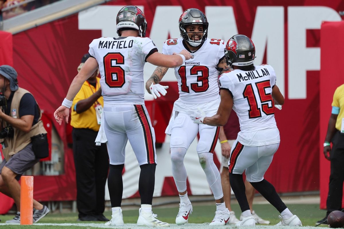 Sep 8, 2024; Tampa, Florida, USA;  Tampa Bay Buccaneers wide receiver Mike Evans (13)  is congratulated by quarterback Baker Mayfield (6) and wide receiver Jalen McMillan (15) after he scored a touchdown against the Washington Commanders during the first half at Raymond James Stadium. Mandatory Credit: Kim Klement Neitzel-Imagn Images