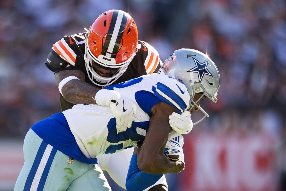 Sep 8, 2024; Cleveland, Ohio, USA; Cleveland Browns safety Juan Thornhill (1) tackles Dallas Cowboys wide receiver Jalen Brooks (83) during the second quarter at Huntington Bank Field. Mandatory Credit: Scott Galvin-Imagn Images