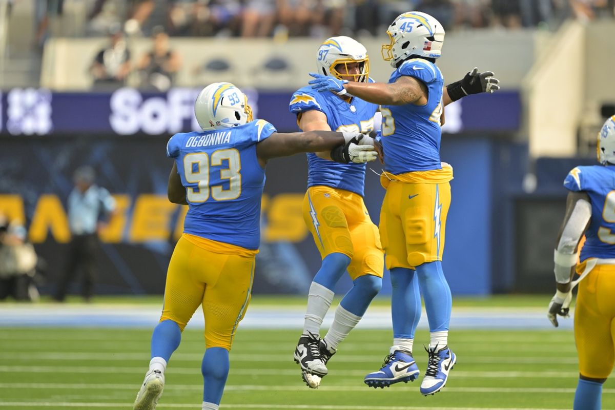 Sep 8, 2024; Inglewood, California, USA;  Los Angeles Chargers linebacker Joey Bosa (97) celebrates with defensive tackle Otito Ogbonnia (93) and linebacker Tuli Tuipulotu (45) after forcing a fumble in the second half against the Las Vegas Raiders at SoFi Stadium. Mandatory Credit: Jayne Kamin-Oncea-Imagn Images