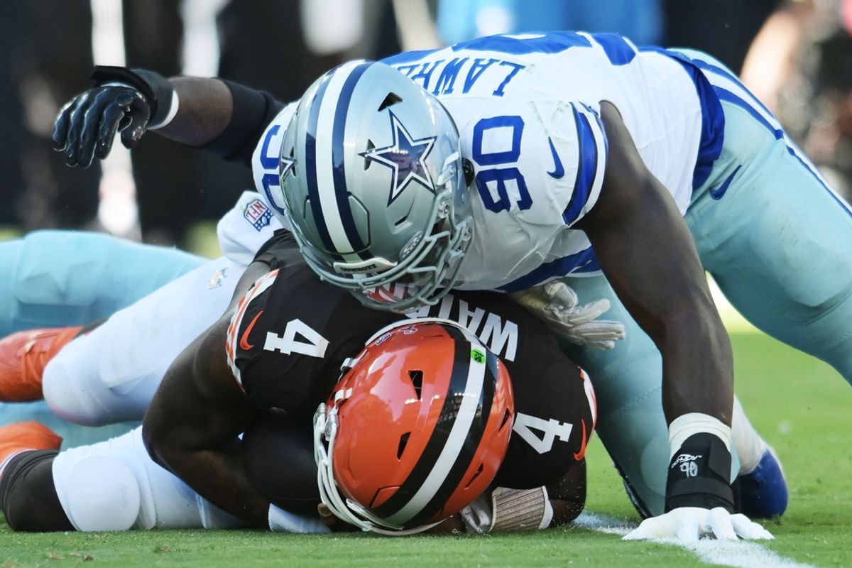 Sep 8, 2024; Cleveland, Ohio, USA; Dallas Cowboys defensive end DeMarcus Lawrence (90) lies on Cleveland Browns quarterback Deshaun Watson (4) after a sack during the first quarter at Huntington Bank Field. Mandatory Credit: Ken Blaze-Imagn Images