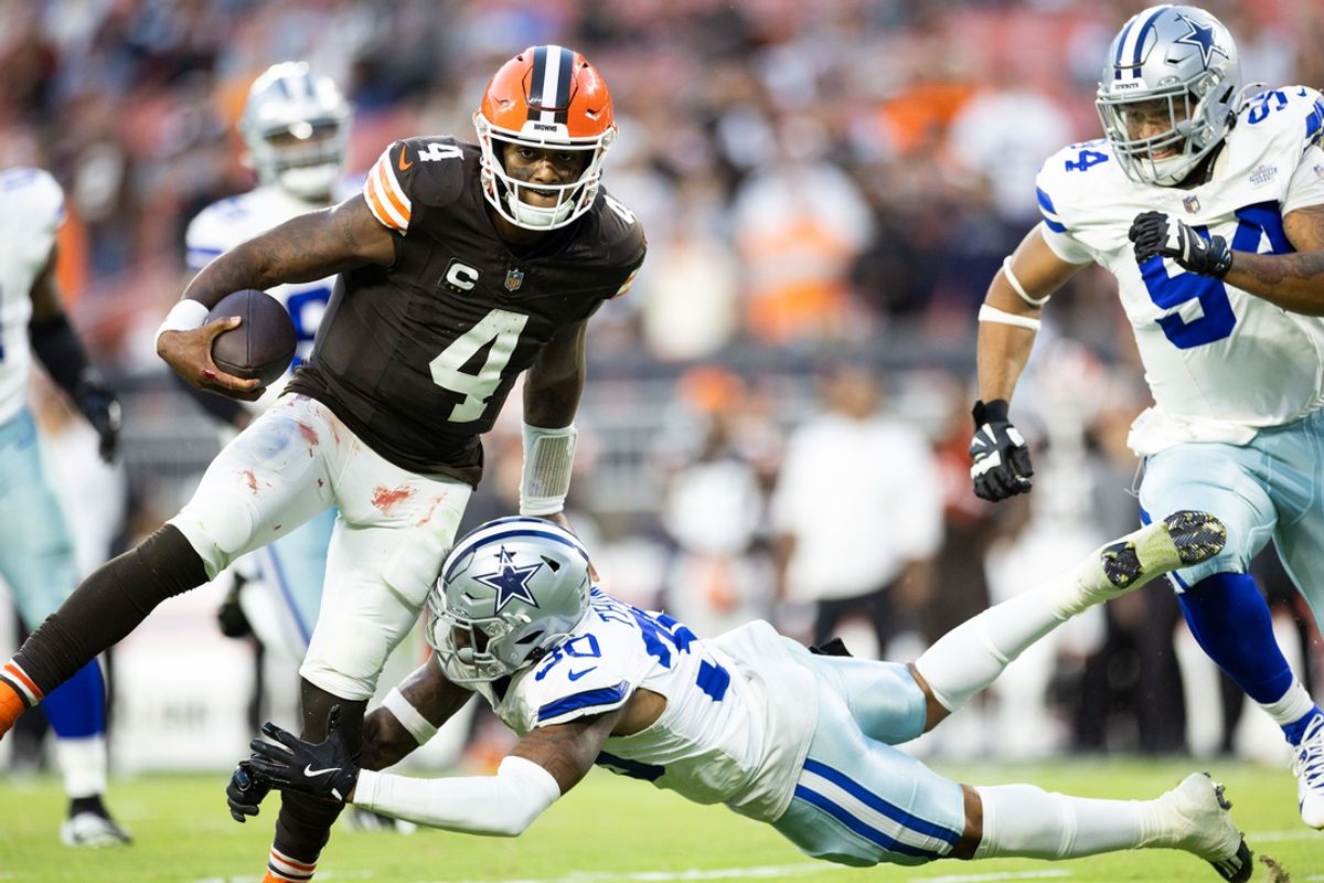 Sep 8, 2024; Cleveland, Ohio, USA; Dallas Cowboys safety Juanyeh Thomas (30) tackles Cleveland Browns quarterback Deshaun Watson (4) during the fourth quarter at Huntington Bank Field. Mandatory Credit: Scott Galvin-Imagn Images