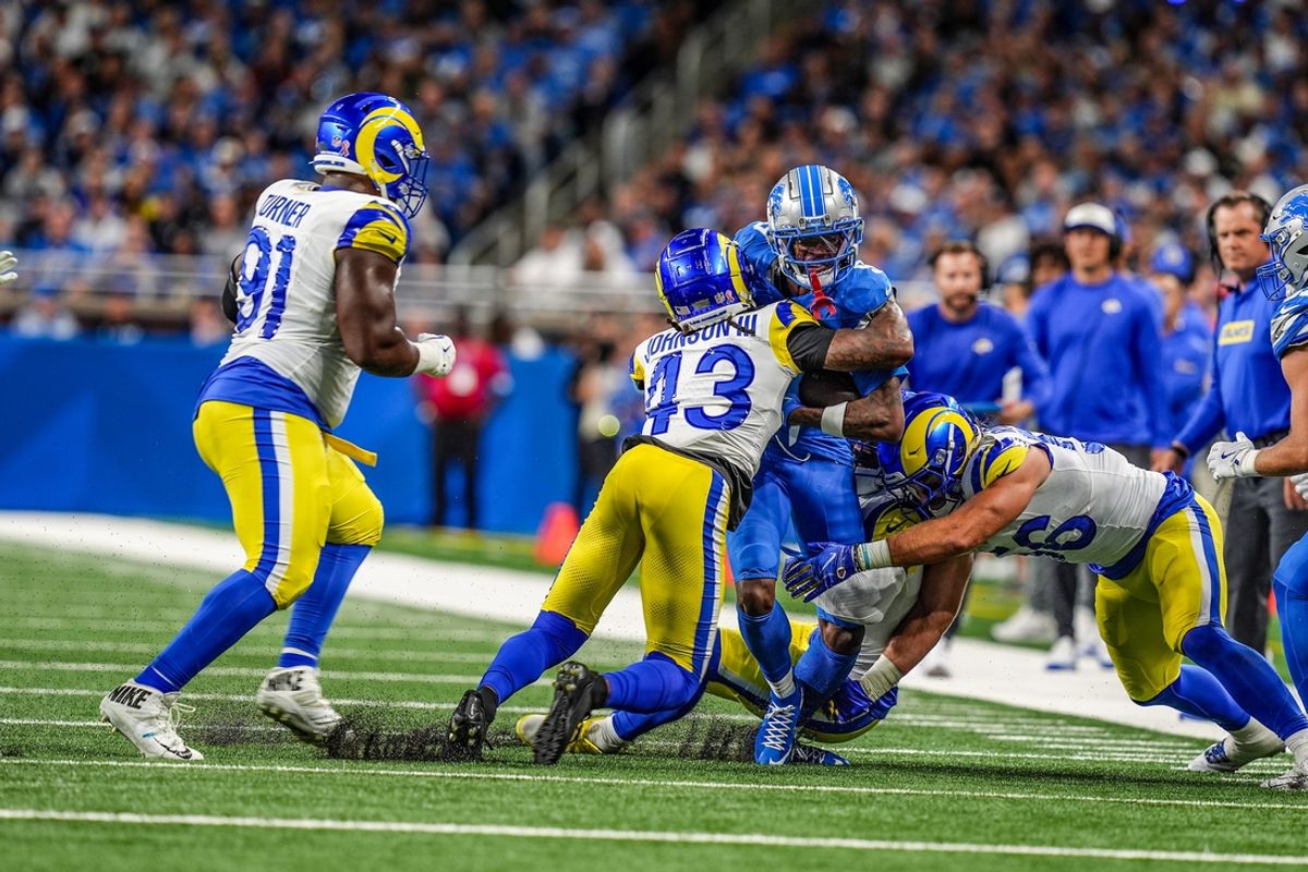 Detroit Lions wide receiver Jameson Williams (9) is tackled by Los Angeles Rams safety John Johnson III (43) and Los Angeles Rams linebacker Christian Rozeboom (56) after making a catch during the first half of the Detroit Lions season opener against the Los Angeles Rams at Ford Field in Detroit, on Sunday, Sept. 8. 2024.