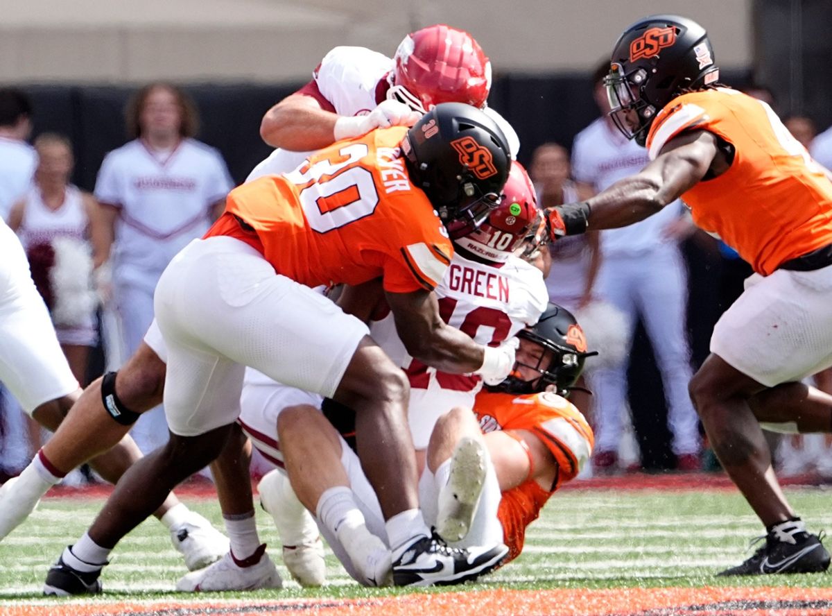 Oklahoma State's Collin Oliver (30) sacks Arkansas' Taylen Green (10) in the first half of the college football game between the Oklahoma State Cowboys and the Arkansas Razorbacks at Boone Pickens Stadium in Stillwater, Okla., Saturday, Sept., 7, 2024.
