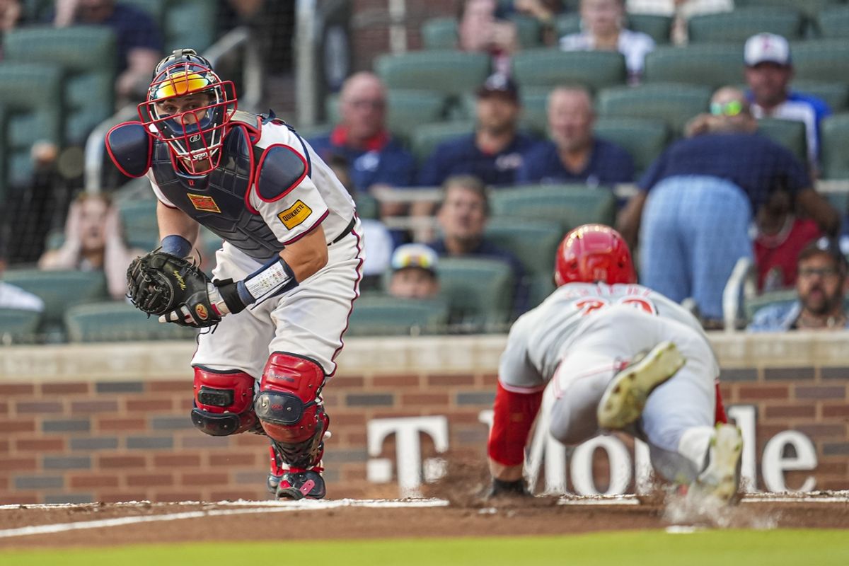 Sep 9, 2024; Cumberland, Georgia, USA; Atlanta Braves catcher Sean Murphy (12) is too large to tag out Cincinnati Reds center fielder TJ Friedl (29) during the second inning at Truist Park. Mandatory Credit: Dale Zanine-Imagn Images