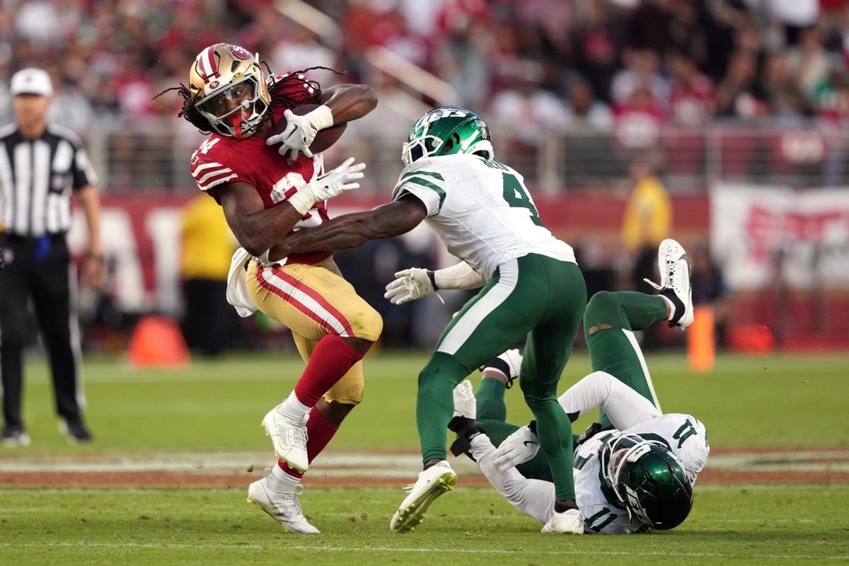 Sep 9, 2024; Santa Clara, California, USA; San Francisco 49ers running back Jordan Mason (left) carries the ball against New York Jets cornerback D.J. Reed (4) during the third quarter at Levi's Stadium. Mandatory Credit: Darren Yamashita-Imagn Images