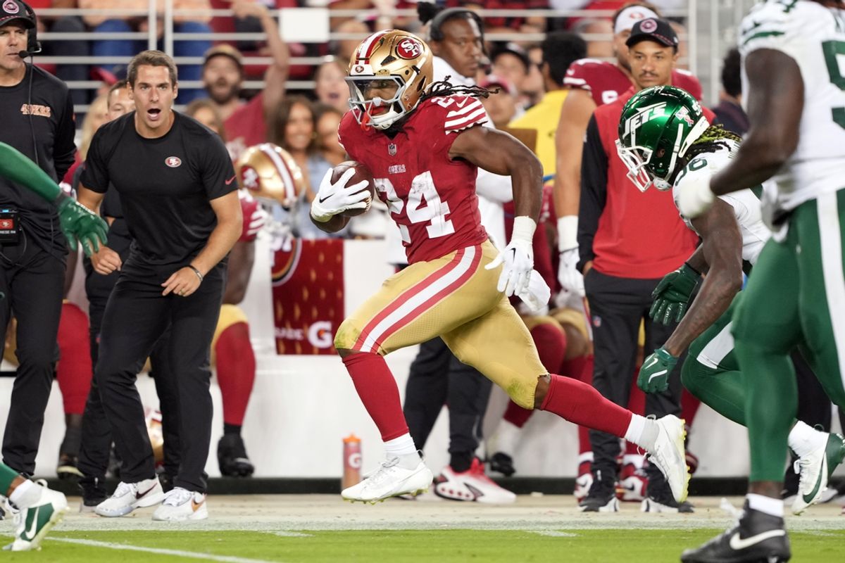 Sep 9, 2024; Santa Clara, California, USA; San Francisco 49ers running back Jordan Mason (24) carries the ball against New York Jets linebacker Quincy Williams (obscured right) during the fourth quarter at Levi's Stadium. Mandatory Credit: Darren Yamashita-Imagn Images