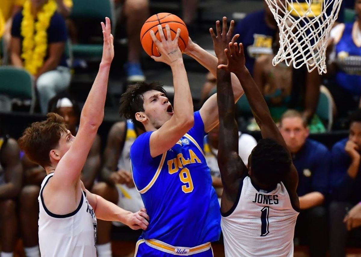 Nov 20, 2023; Honolulu, Hawaii, USA;  UCLA Bruins forward Berke Buyuktuncel (9) shoots the ball against Marquette Golden Eagles guard Kam Jones (1) during the first period at SimpliFi Arena at Stan Sheriff Center.