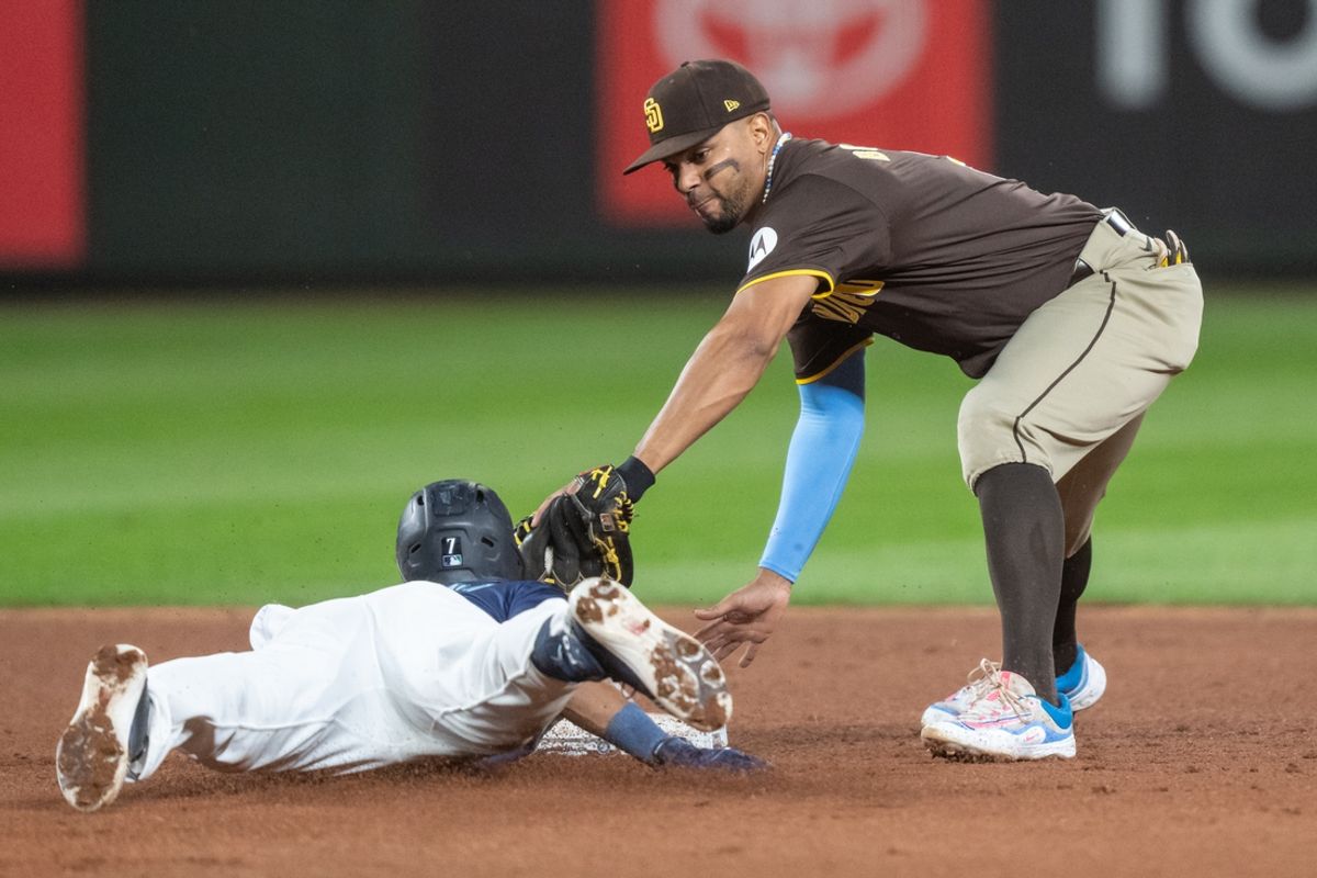 Sep 10, 2024; Seattle, Washington, USA;  San Diego Padres shortstop Xander Bogaerts (2) tags out Seattle Mariners second baseman Jorge Polanco (7) at second base during the fourth inning at T-Mobile Park. Mandatory Credit: Stephen Brashear-Imagn Images