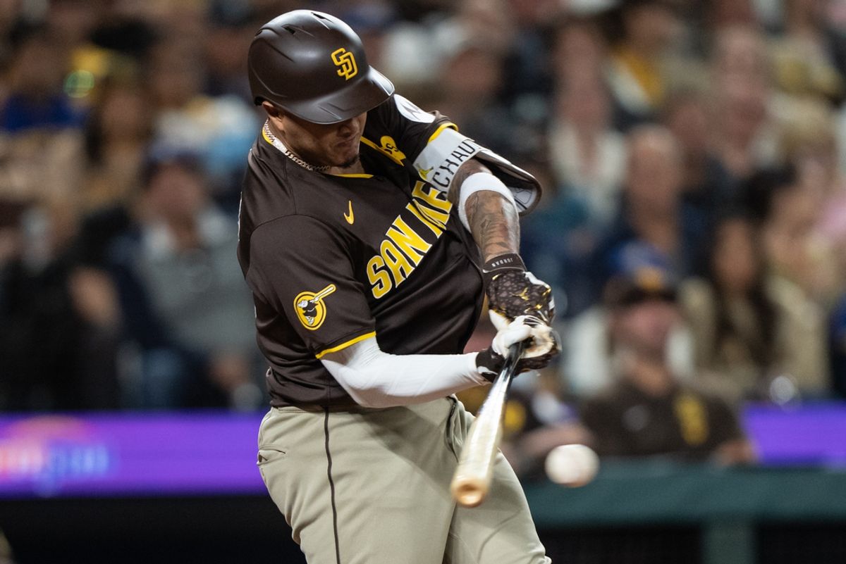 Sep 10, 2024; Seattle, Washington, USA;  San Diego Padres third baseman Manny Machado (13) hits a two-run single during the seventh inning against the Seattle Mariners at T-Mobile Park. Mandatory Credit: Stephen Brashear-Imagn Images