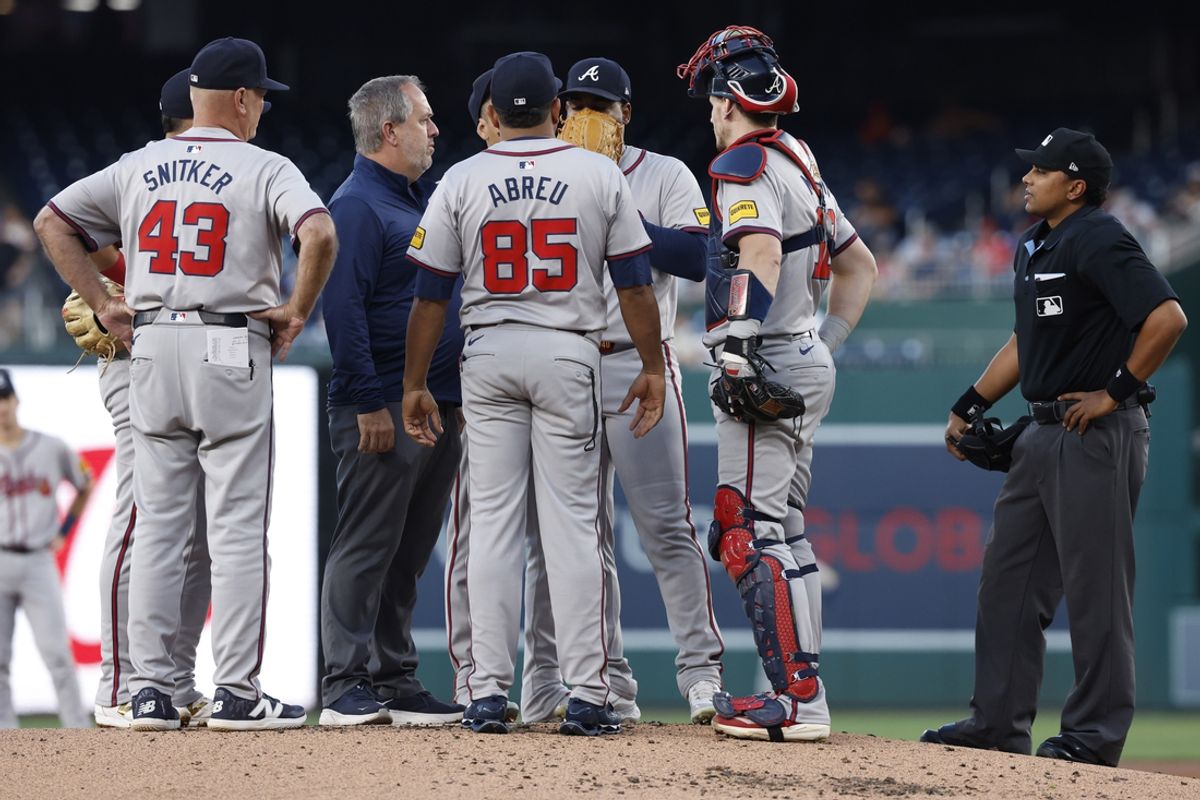 Sep 10, 2024; Washington, District of Columbia, USA;Atlanta Braves pitcher Reynaldo Lopez (40) talks with a member of the training staff as Braves manager Brian Snitker (43) listens against the Washington Nationals during the first inningduring the first inning at Nationals Park. Mandatory Credit: Geoff Burke-Imagn Images