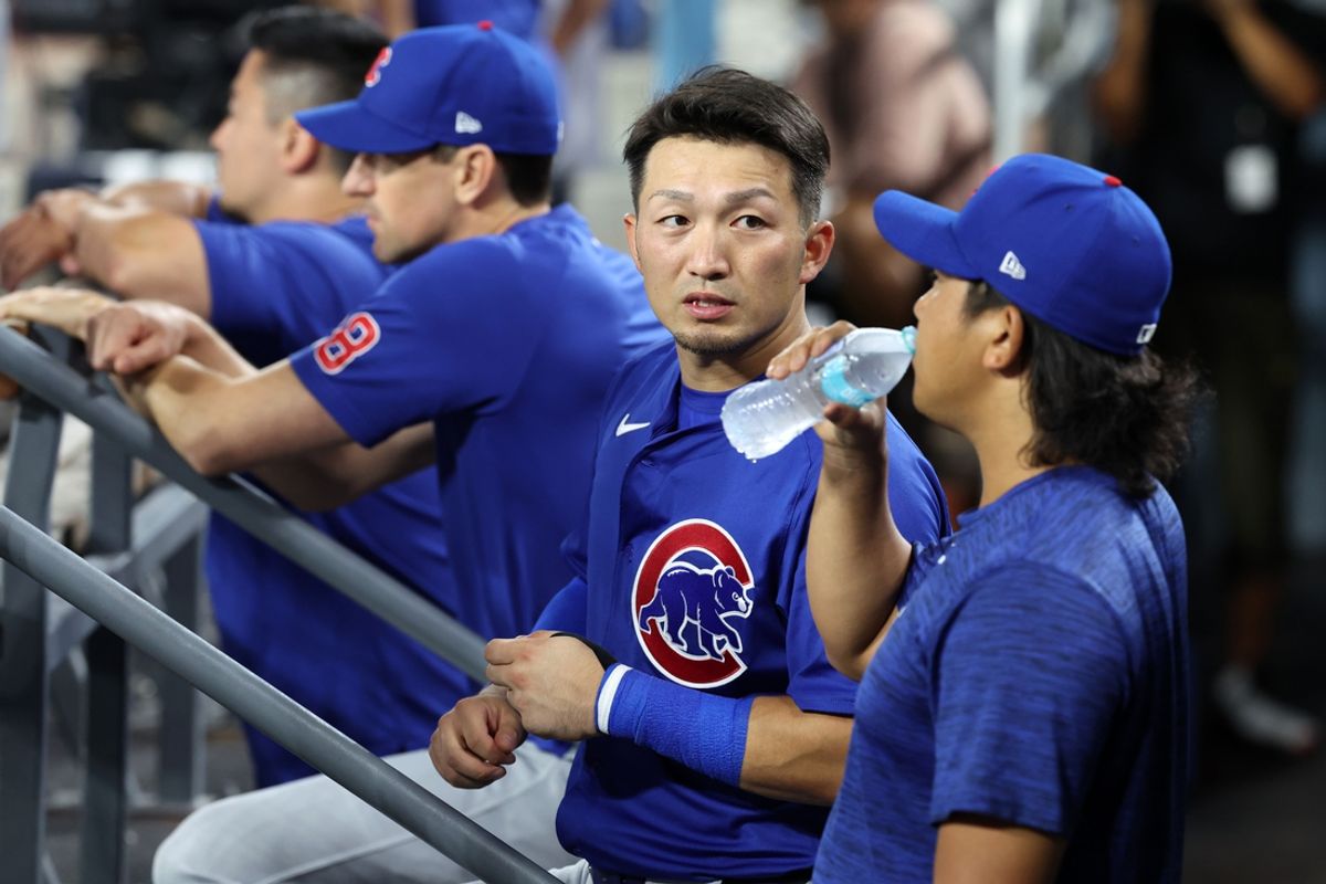 Sep 10, 2024; Los Angeles, California, USA;  Chicago Cubs designated hitter Seiya Suzuki (27, center) talks with starting pitcher Shota Imanaga (18, right) during the ninth inning against the Los Angeles Dodgers at Dodger Stadium. Mandatory Credit: Kiyoshi Mio-Imagn Images