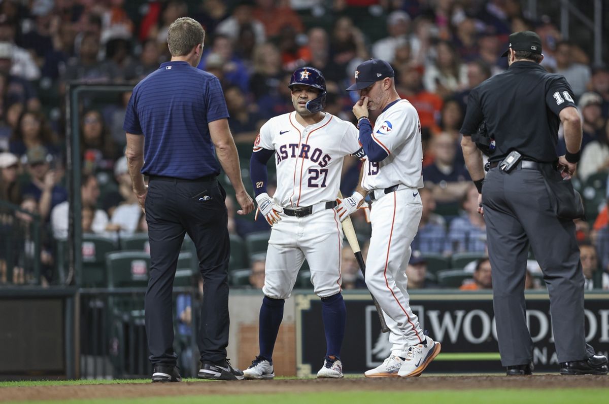 Sep 11, 2024; Houston, Texas, USA; Houston Astros second baseman Jose Altuve (27) talks with manager Joe Espada (19) and medical staff after an apparent injury during the fifth inning against the Oakland Athletics at Minute Maid Park. Mandatory Credit: Troy Taormina-Imagn Images