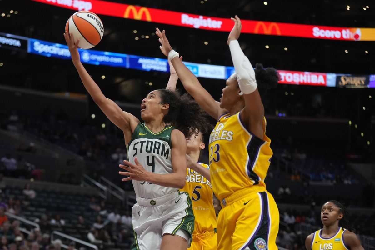 Sep 11, 2024; Los Angeles, California, USA; Seattle Storm guard Skylar Diggins-Smith (4) shoots the ball against LA Sparks forward Dearica Hamby (5) and forward Azura Stevens (23) in the second half at Crypto.com Arena. Mandatory Credit: Kirby Lee-Imagn Images