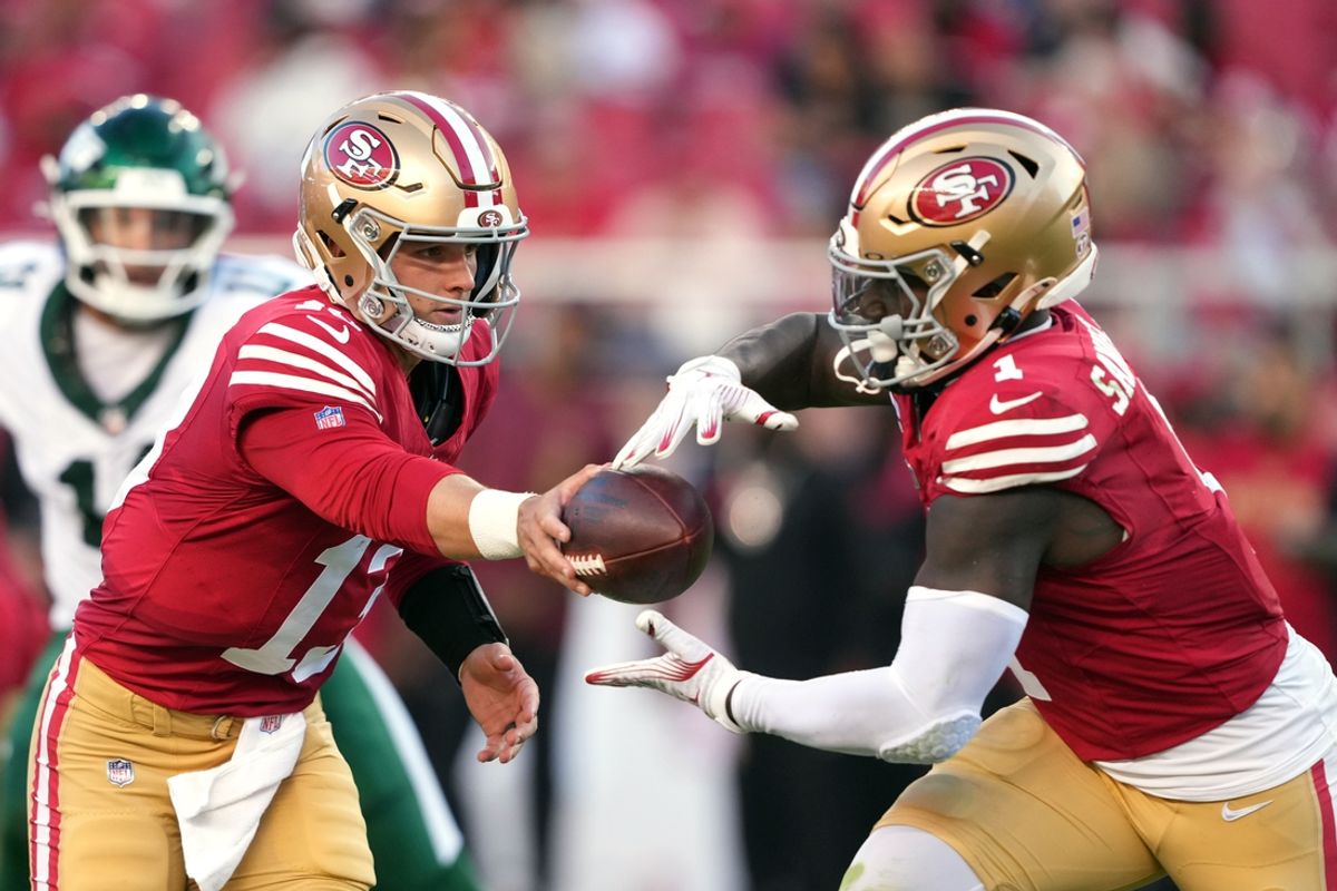 Sep 9, 2024; Santa Clara, California, USA; San Francisco 49ers quarterback Brock Purdy (left) hands off to wide receiver Deebo Samuel Sr. (right) during the second quarter against the New York Jets at Levi's Stadium. Mandatory Credit: Darren Yamashita-Imagn Images