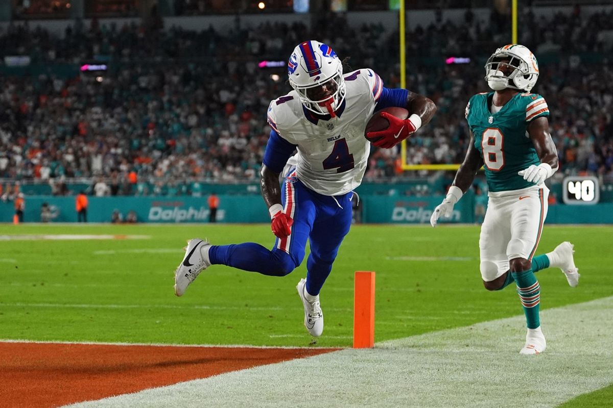 Sep 12, 2024; Miami Gardens, Florida, USA; Buffalo Bills running back James Cook (4) runs for a touchdown past Miami Dolphins safety Jevon Holland (8) during the first half at Hard Rock Stadium. Mandatory Credit: Jasen Vinlove-Imagn Images