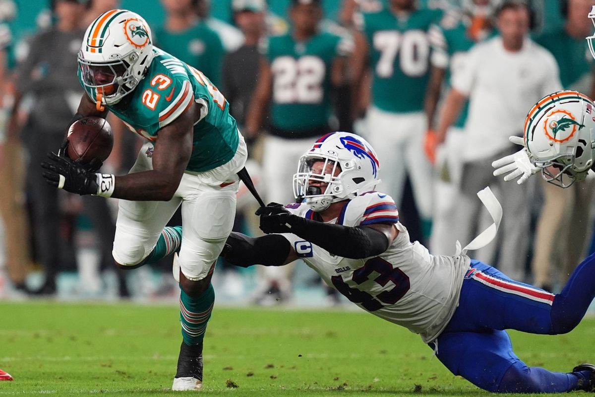 Sep 12, 2024; Miami Gardens, Florida, USA; Buffalo Bills linebacker Terrel Bernard (43) reaches for Miami Dolphins running back Jeff Wilson Jr. (23) during the first half at Hard Rock Stadium. Mandatory Credit: Jasen Vinlove-Imagn Images