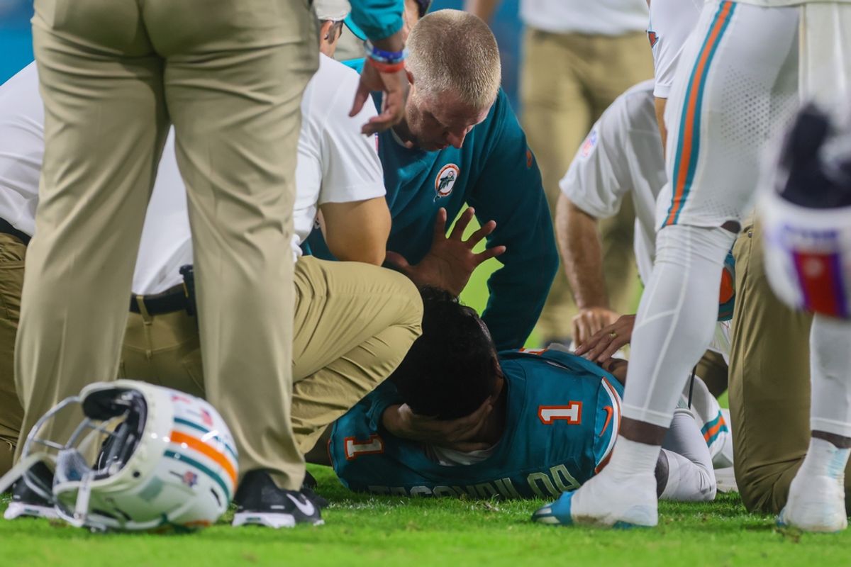 Sep 12, 2024; Miami Gardens, Florida, USA; Miami Dolphins quarterback Tua Tagovailoa (1) is checked on by trainers after an apparent injury against the Buffalo Bills during the third quarter at Hard Rock Stadium. Mandatory Credit: Sam Navarro-Imagn Images