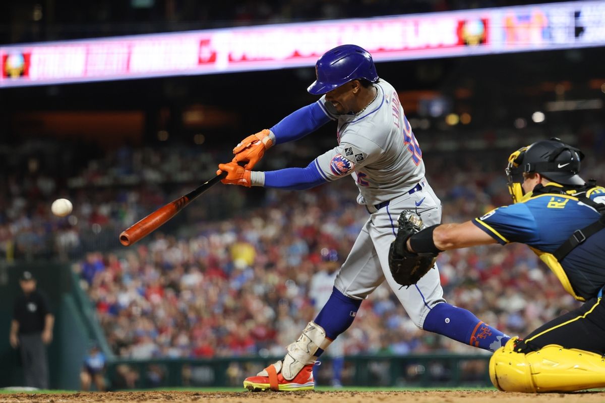 Sep 13, 2024; Philadelphia, Pennsylvania, USA; New York Mets shortstop Francisco Lindor (12) hits a single during the fifth inning against the Philadelphia Phillies at Citizens Bank Park. Mandatory Credit: Bill Streicher-Imagn Images
