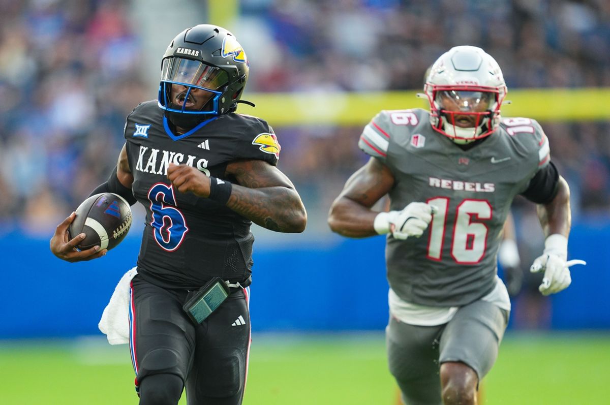 Sep 13, 2024; Kansas City, Kansas, USA; Kansas Jayhawks quarterback Jalon Daniels (6) runs for a touchdown against UNLV Rebels linebacker Mani Powell (16) during the first half at Children's Mercy Park. Mandatory Credit: Jay Biggerstaff-Imagn Images