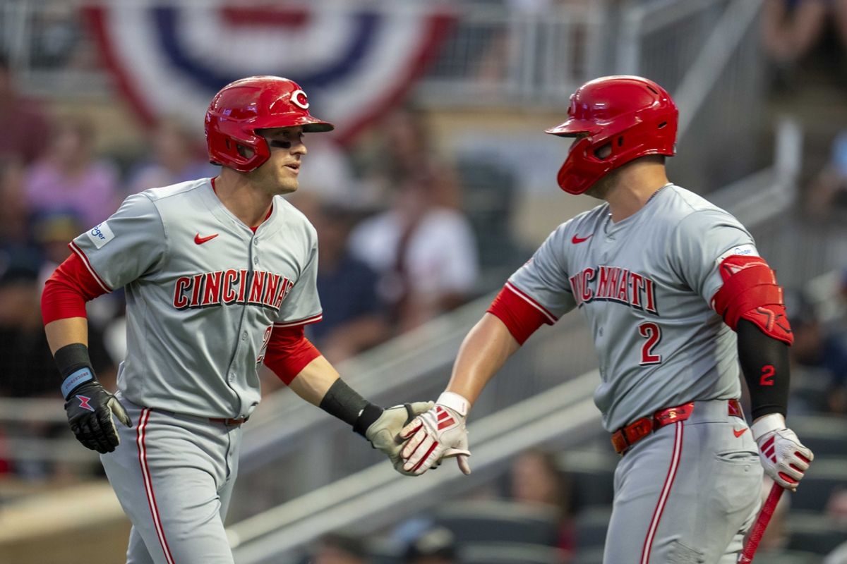 Sep 13, 2024; Minneapolis, Minnesota, USA; Cincinnati Reds center fielder TJ Friedl (29) celebrates with first baseman Ty France (2) after hitting a solo home run against the Minnesota Twins in the second inning at Target Field. Mandatory Credit: Jesse Johnson-Imagn Images