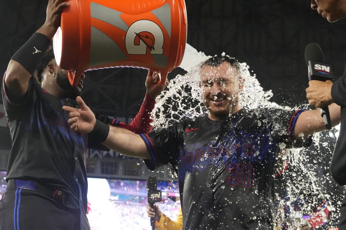 Sep 13, 2024; Toronto, Ontario, CAN; Toronto Blue Jays catcher Alejandro Kirk (30) gets doused with ice water after hitting a walk off rbi single against the St. Louis Cardinals in the 11th inning at Rogers Centre. Mandatory Credit: John E. Sokolowski-Imagn Images