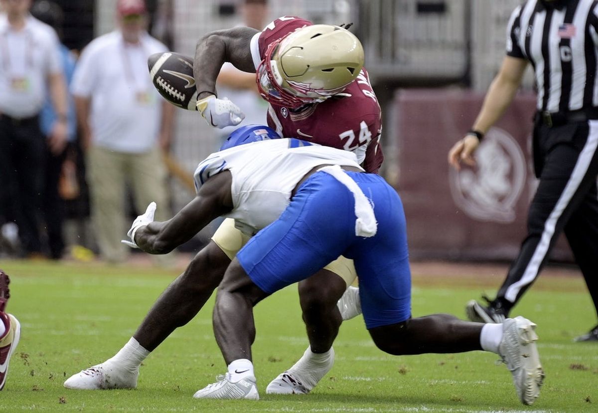 Sep 14, 2024; Tallahassee, Florida, USA; Memphis Tigers defensive back An'Darius Coffey (4) forces a fumble by Florida State Seminoles running back Roydell Williams (24) during the first half at Doak S. Campbell Stadium. Mandatory Credit: Melina Myers-Imagn Images