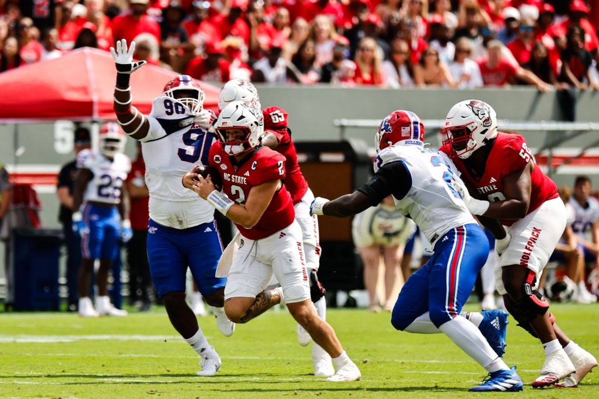 Sep 14, 2024; Raleigh, North Carolina, USA;  North Carolina State Wolfpack quarterback Grayson McCall (2) runs with the football against the Louisiana Tech Bulldogs during the first half at Carter-Finley Stadium. Mandatory Credit: Jaylynn Nash-Imagn Images