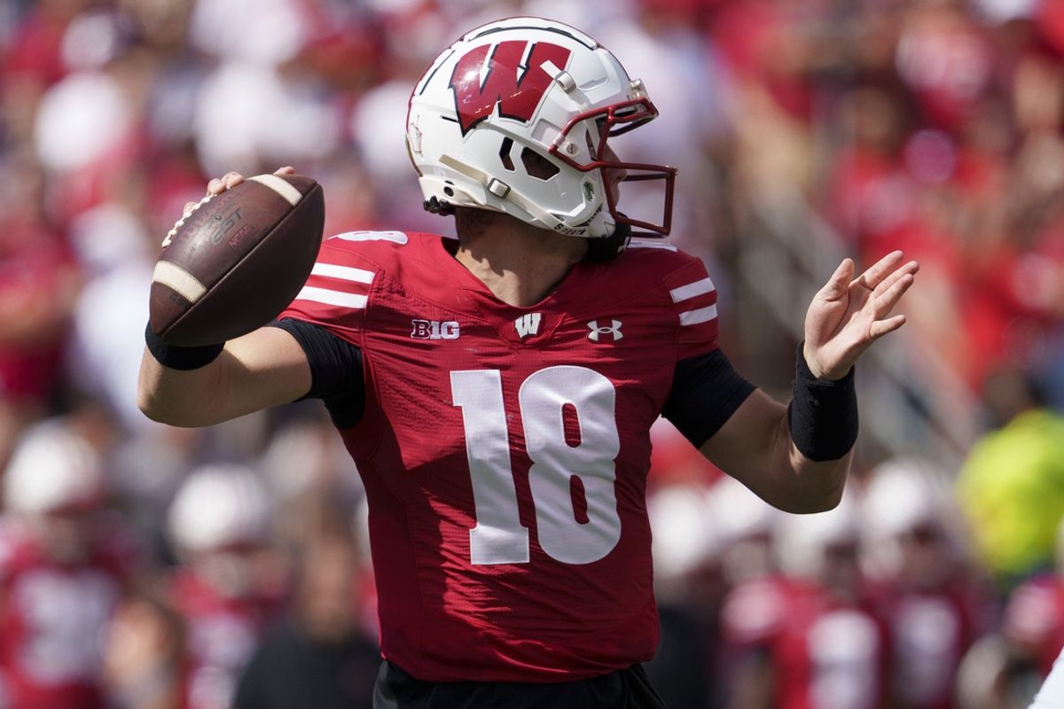 Sep 14, 2024; Madison, Wisconsin, USA;  Wisconsin Badgers quarterback Braedyn Locke (18) throws a pass during the second quarter against the Alabama Crimson Tide at Camp Randall Stadium. Mandatory Credit: Jeff Hanisch-Imagn Images