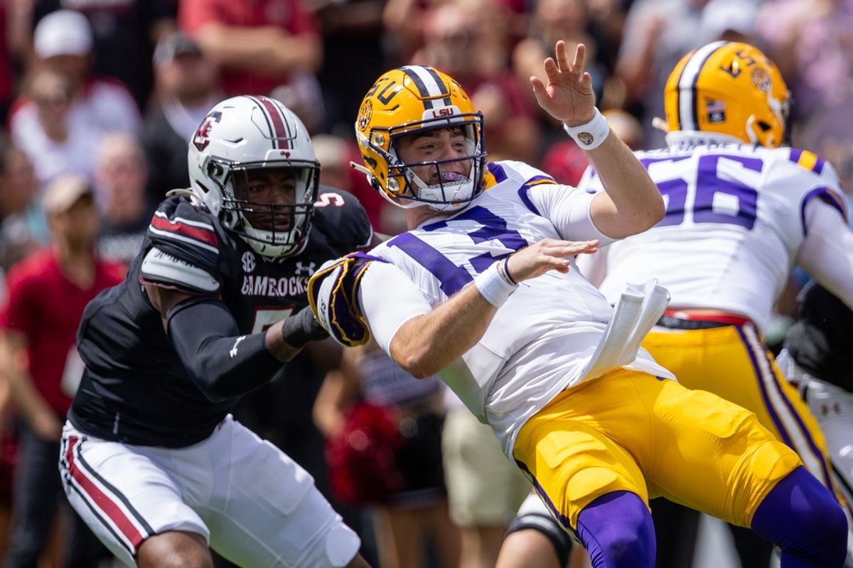 Sep 14, 2024; Columbia, South Carolina, USA; South Carolina Gamecocks edge Kyle Kennard (5) pulls down LSU Tigers quarterback Garrett Nussmeier (13) during the first quarter at Williams-Brice Stadium. Mandatory Credit: Scott Kinser-Imagn Images