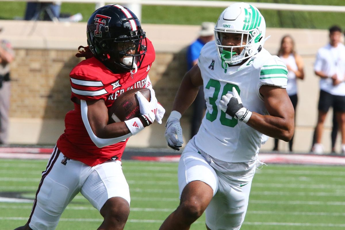 Sep 14, 2024; Lubbock, Texas, USA;  Texas Tech Red Raiders wide receiver Jordan Brown (4) runs the ball against North Texas Mean Green defensive back Jaylen Smith (36) in the first half at Jones AT&T Stadium and Cody Campbell Field. Mandatory Credit: Michael C. Johnson-Imagn Images