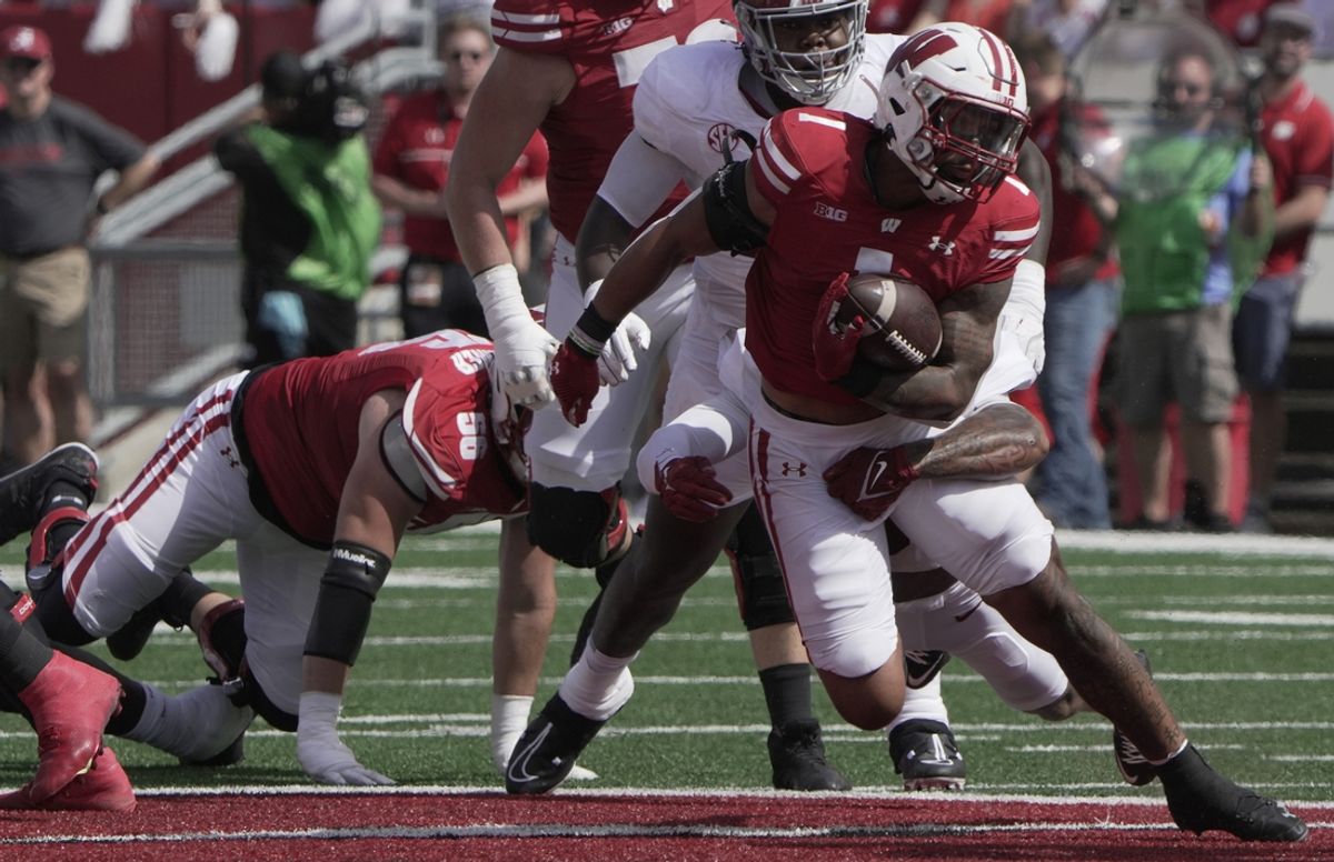 Sep 14, 2024; Madison, Wisconsin, USA; Wisconsin Bulldogs running back Chez Mellusi (1) runs the ball against the Alabama Crimson Tide during the first quarter at Camp Randall Stadium. Mandatory Credit: Mark Hoffman/USA TODAY Network via Imagn Images