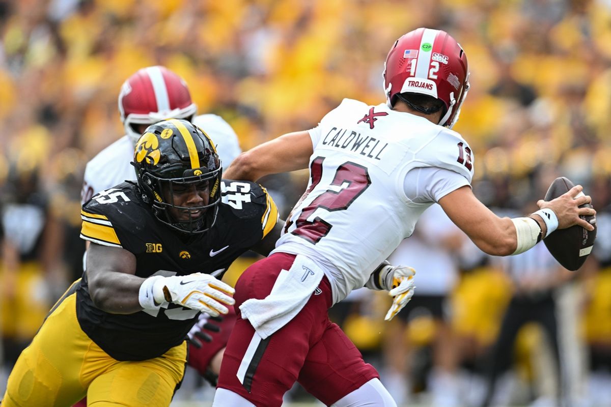 Sep 14, 2024; Iowa City, Iowa, USA; Iowa Hawkeyes defensive lineman Deontae Craig (45) pressures Troy Trojans quarterback Matthew Caldwell (12) during the first quarter at Kinnick Stadium. Mandatory Credit: Jeffrey Becker-Imagn Images