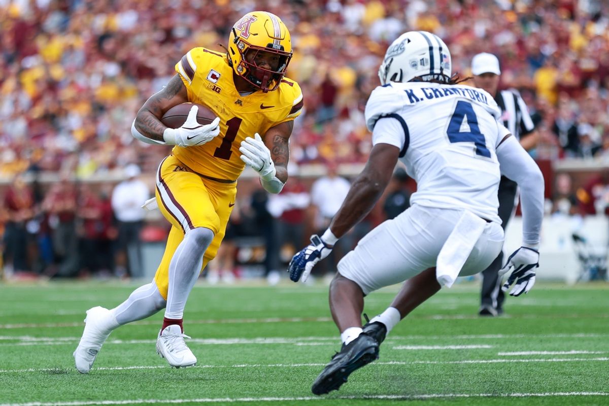 Sep 14, 2024; Minneapolis, Minnesota, USA; Minnesota Golden Gophers running back Darius Taylor (1) runs the ball as Nevada Wolf Pack safety Kitan Crawford (4) defends during the first half at Huntington Bank Stadium. Mandatory Credit: Matt Krohn-Imagn Images