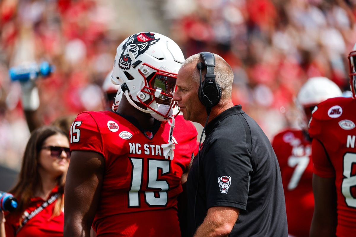 Sep 14, 2024; Raleigh, North Carolina, USA;  North Carolina State Wolfpack tight end Justin Joly (15) and head coach Dave Doeren talk during the second half against the Louisiana Tech Bulldogs at Carter-Finley Stadium. Mandatory Credit: Jaylynn Nash-Imagn Images