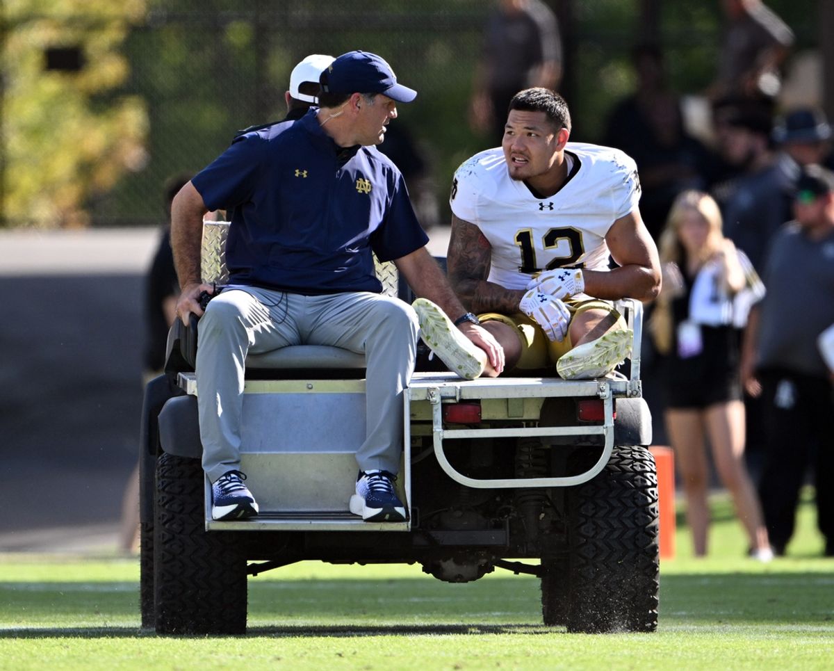 Sep 14, 2024; West Lafayette, Indiana, USA; Notre Dame Fighting Irish defensive lineman Jordan Botelho (12) is carted off the field with an apparent injury during the second quarter against the Purdue Boilermakers at Ross-Ade Stadium. Mandatory Credit: Marc Lebryk-Imagn Images
