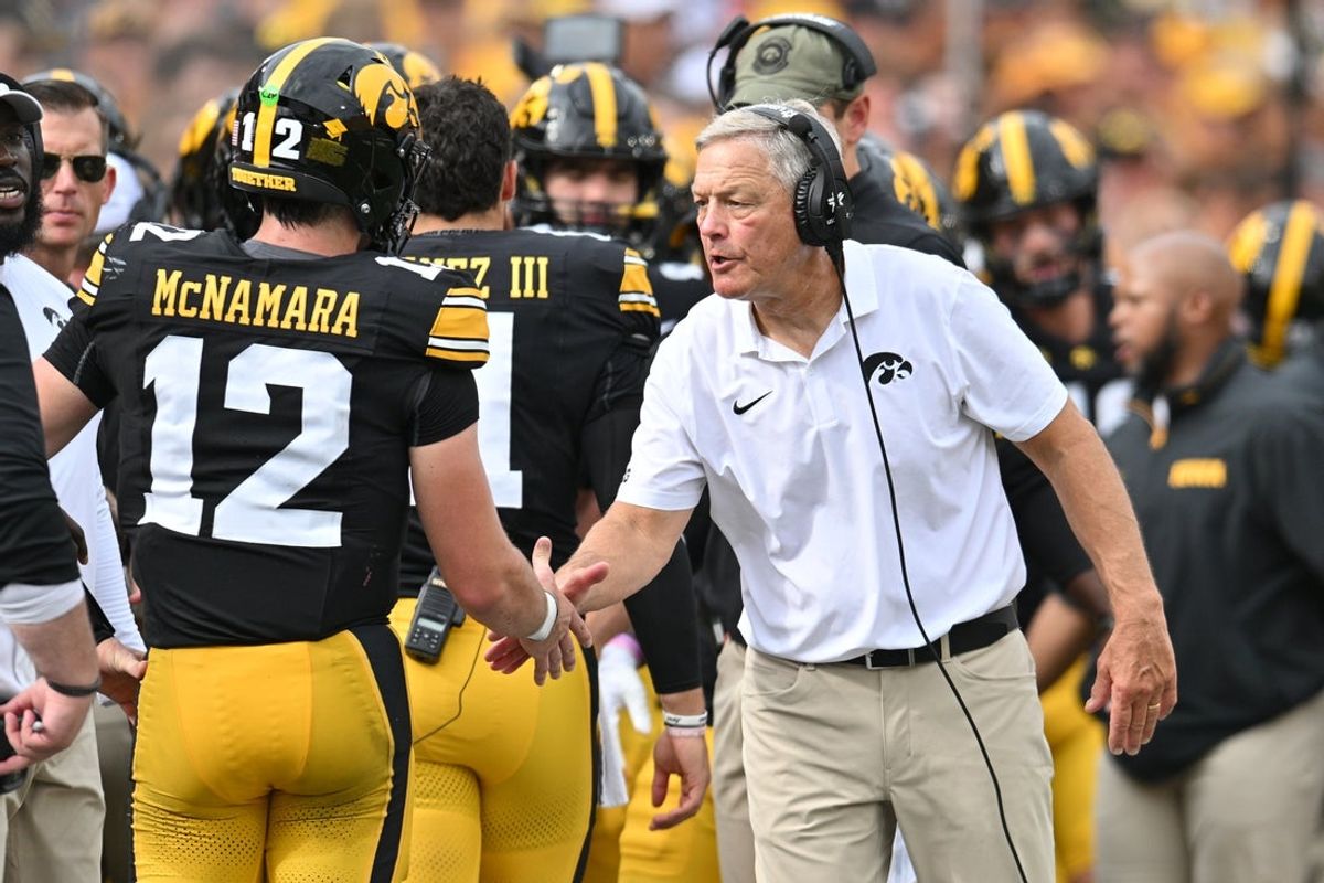 Sep 14, 2024; Iowa City, Iowa, USA; Iowa Hawkeyes head coach Kirk Ferentz reacts with quarterback Cade McNamara (12) after a touchdown against the Troy Trojans during the second quarter at Kinnick Stadium. Mandatory Credit: Jeffrey Becker-Imagn Images