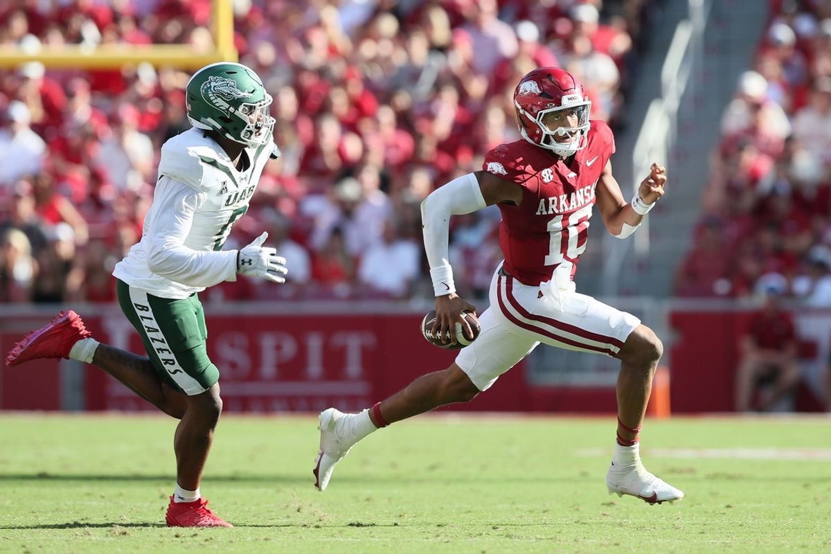 Sep 14, 2024; Fayetteville, Arkansas, USA; Arkansas Razorbacks quarterback Taylen Green (10) rushes in the second quarter as UAB Blazers edge Desmond Little (8) defends at Donald W. Reynolds Razorback Stadium. Mandatory Credit: Nelson Chenault-Imagn Images