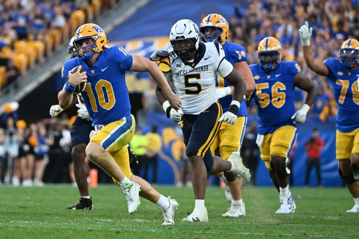 Sep 14, 2024; Pittsburgh, Pennsylvania, USA; Pittsburgh Panthers quarterback Eli Holstein (10) runs against West Virginia Mountaineers defensive lineman Sean Martin (5) during the fourth quarter at Acrisure Stadium. Mandatory Credit: Barry Reeger-Image Images